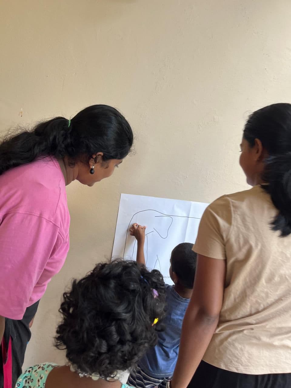 Children and therapists drawing together during an activity session
